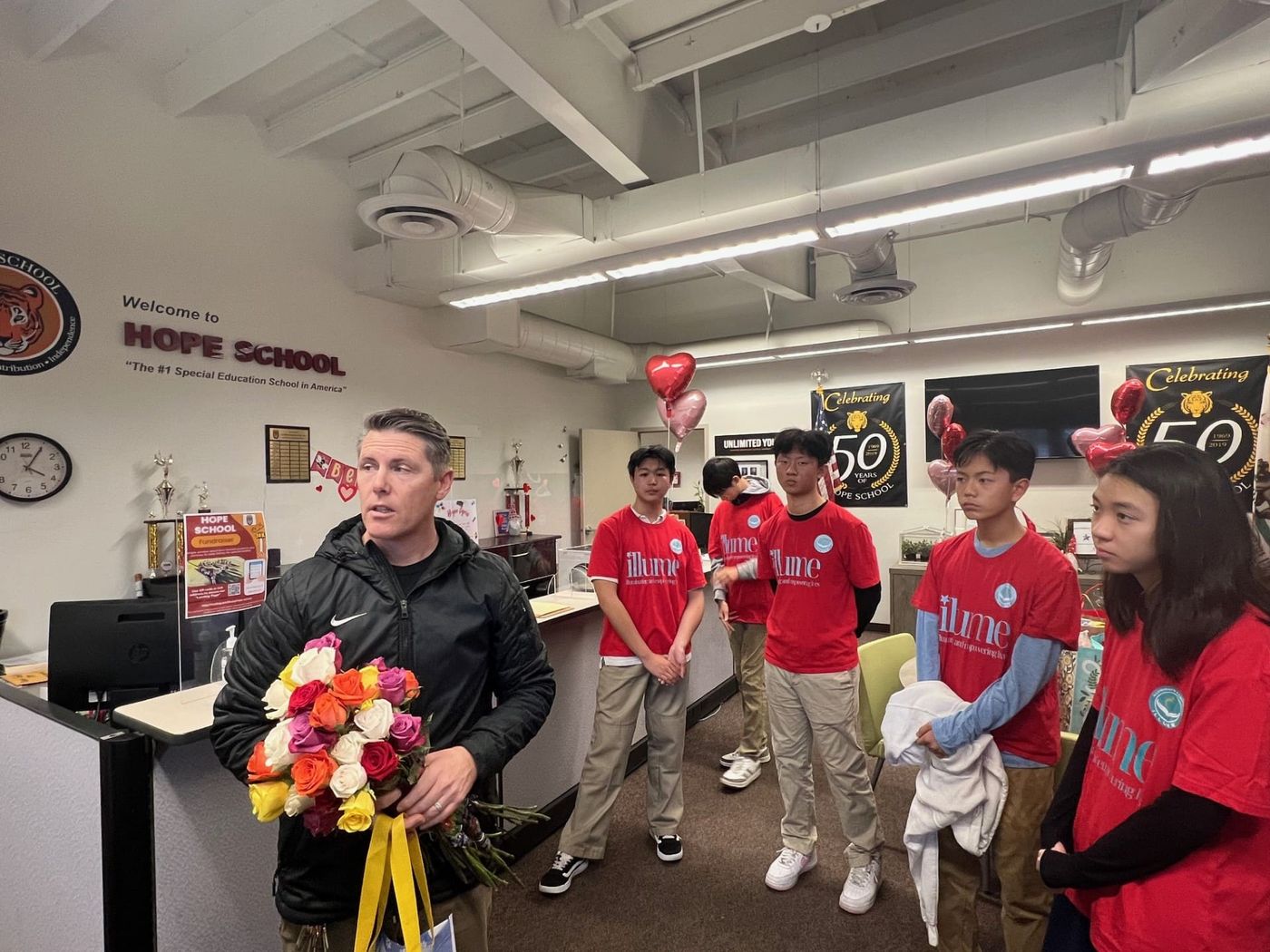 Hope School Vice Principal accepts Rose, Snack, and Stationery donation on behalf of Hope Staff 2/13